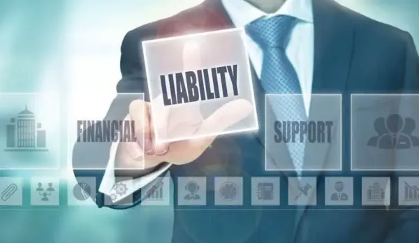 Businessman in a suit touching a digital "Liability" button on a screen with financial and support icons